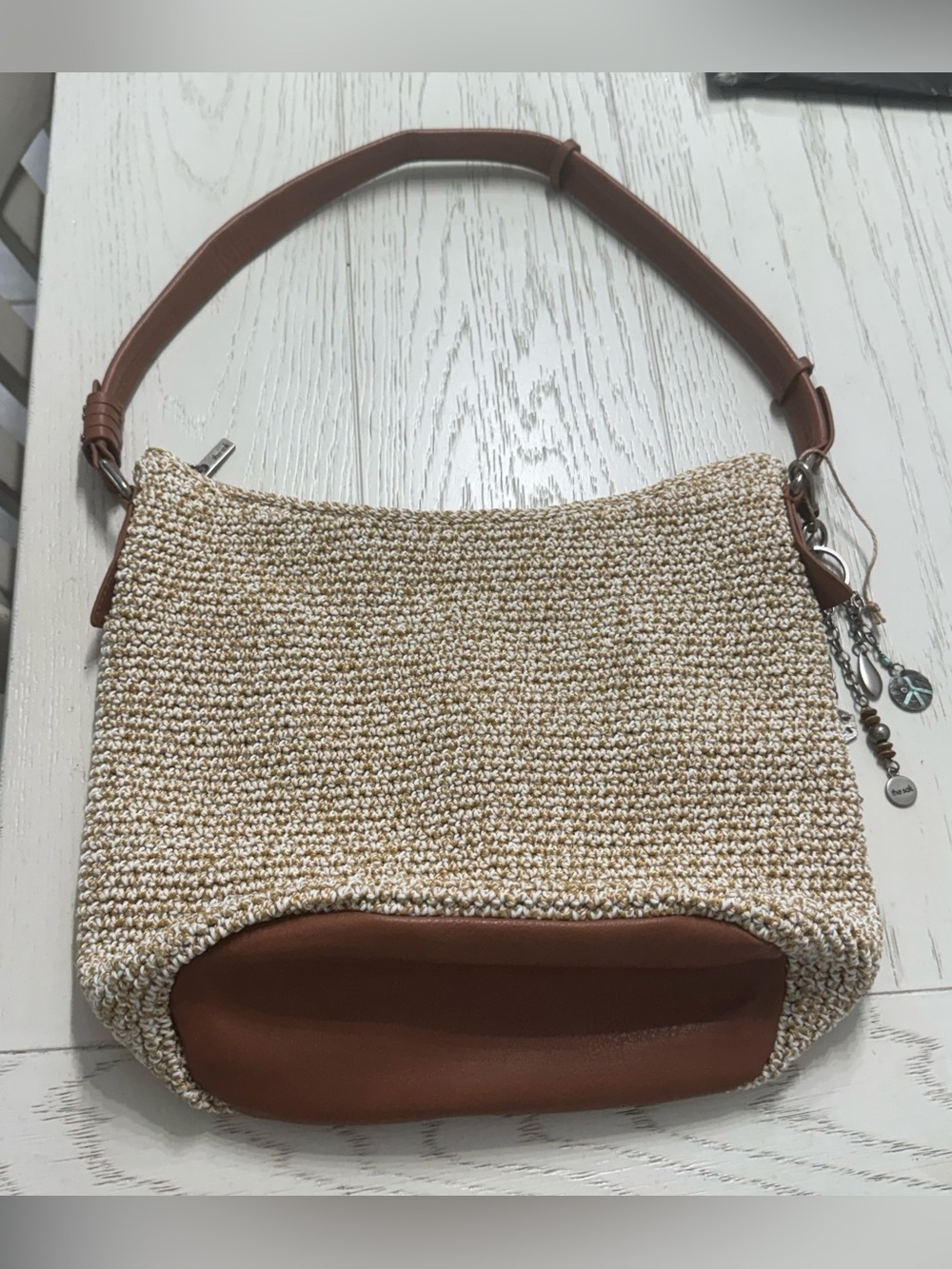 The Sak Woven Straw Shoulder Bag with Brown Trim and Strap